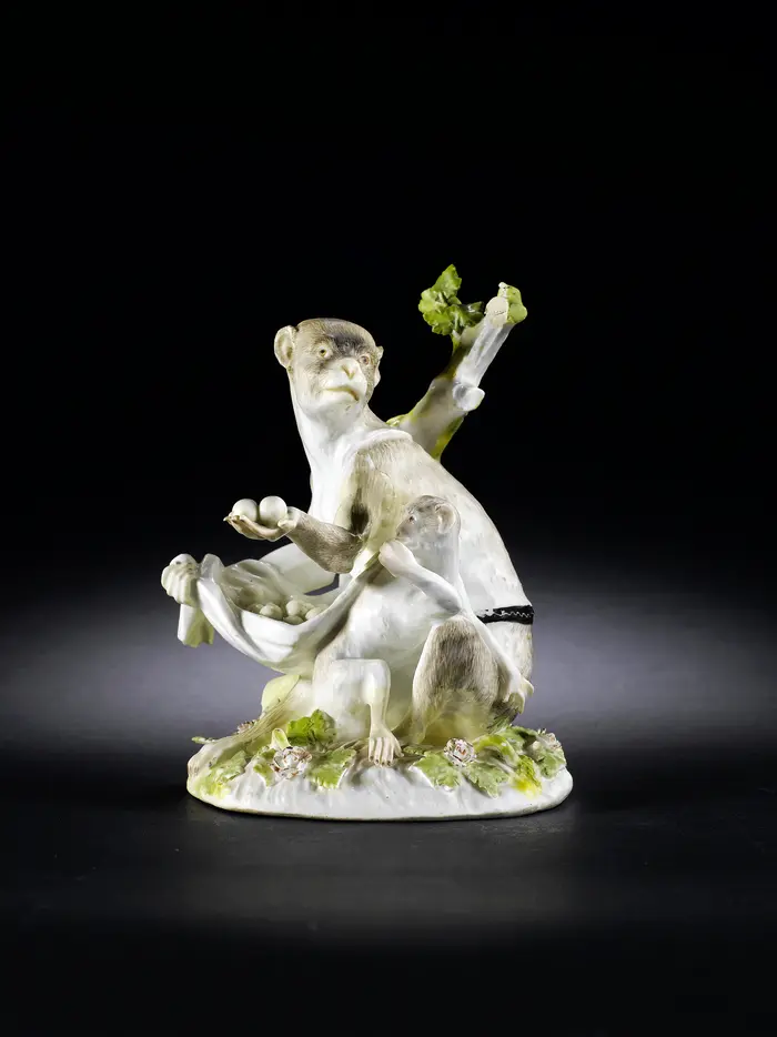 Sitting female monkey with cub